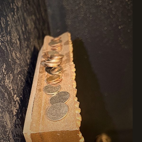 SCRL 0005 Coins left by guests beneath Stella Johnson’s purse as part of the Stella Coin Tradition at Lefty’s.